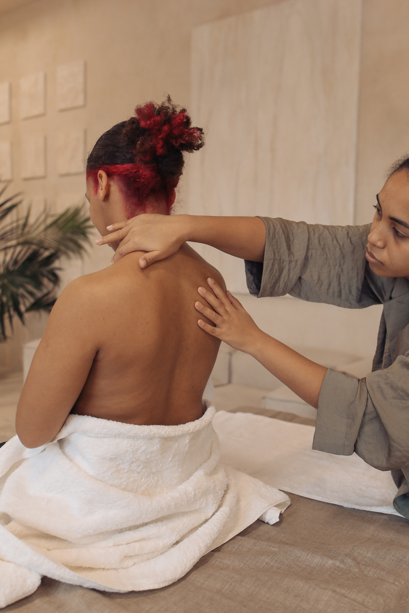 Masseuse Massaging Woman's Back